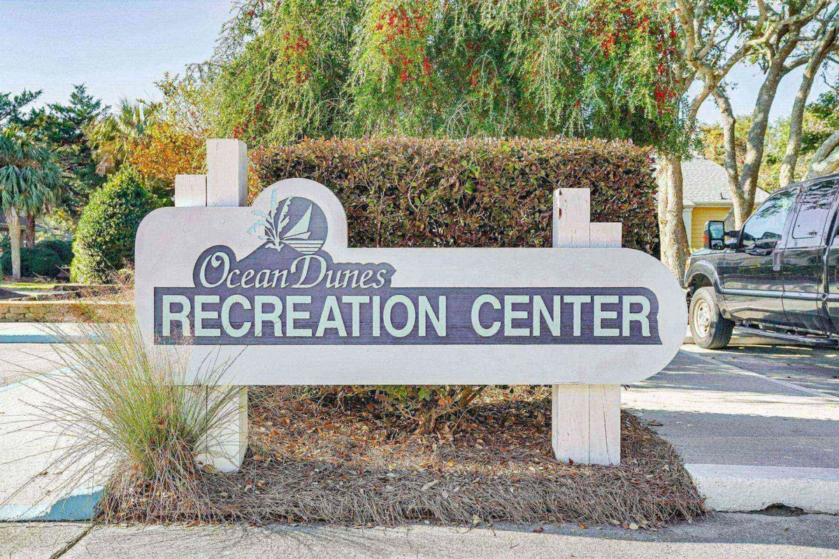 A landscaped recreation area with clear signage and visible vehicles, indicating community amenities and ease of access. The environment suggests outdoor sports or group activities, complemented by a friendly, welcoming mood—echoing the action and communal spirit described in the section.
